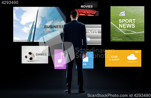 Image of businessman with virtual applications