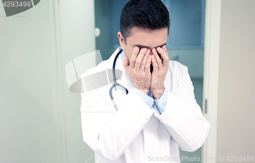 Image of sad or crying male doctor at hospital ward