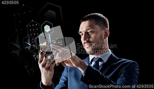 Image of businessman with smartphone and virtual holograms