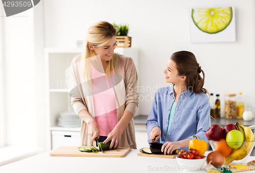 Image of happy family cooking dinner at home kitchen