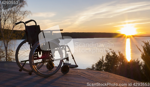 Image of Empty wheelchair standing in a park