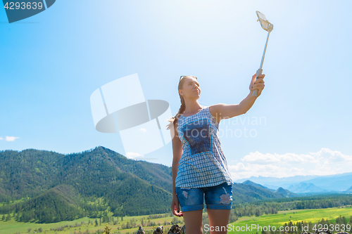 Image of Woman taking selfie on mobile phone