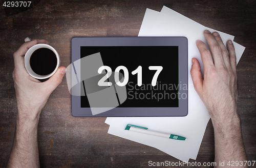Image of Tablet touch computer gadget on wooden table - 2017