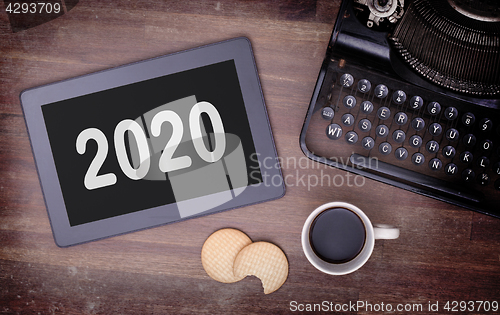 Image of Tablet touch computer gadget on wooden table - 2020