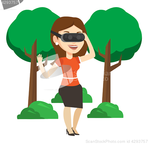 Image of Woman wearing virtual reality headset in the park.