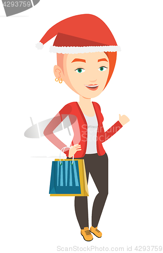 Image of Woman in santa hat shopping for christmas gifts.