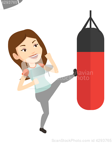 Image of Woman exercising with punching bag.