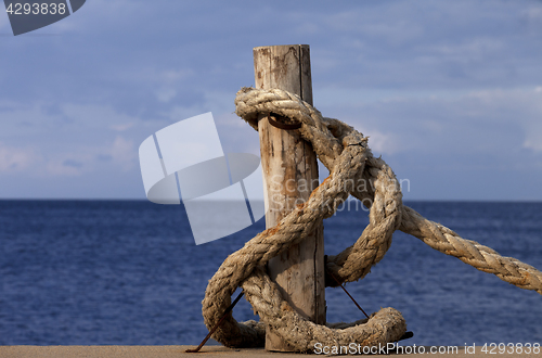 Image of Rope on seafront and sea in sun autumn day