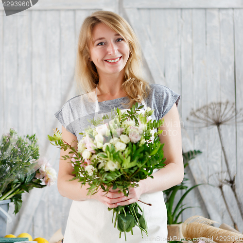 Image of Florists girl working with flowers