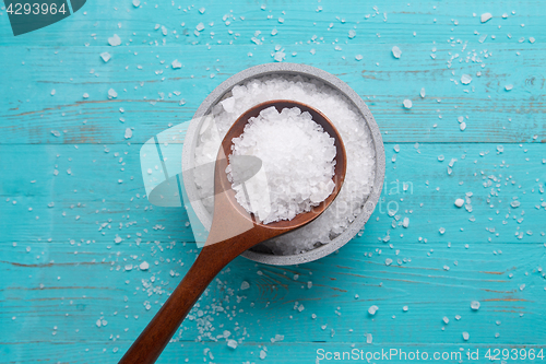 Image of sea salt in stone bowl and wooden spoon