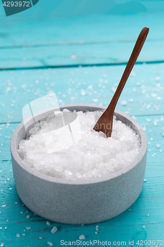 Image of sea salt on wooden background