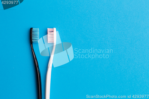 Image of Photo of black , pink toothbrush