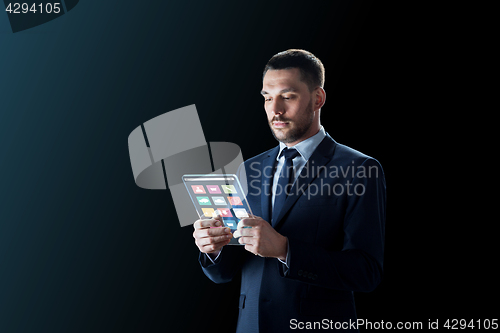 Image of businessman working with transparent tablet pc