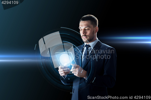 Image of businessman working with transparent tablet pc