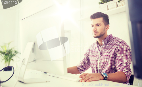 Image of creative man or student with computer at office