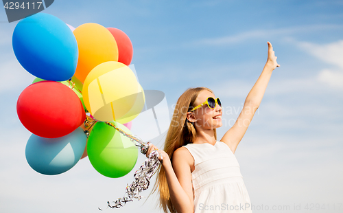 Image of happy girl in sunglasses with air balloons