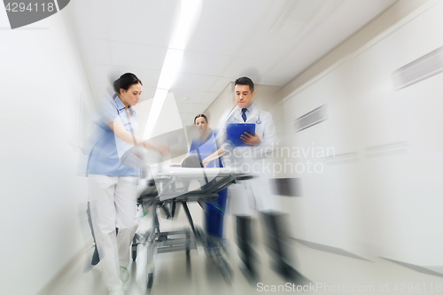 Image of medics and patient on hospital gurney at emergency