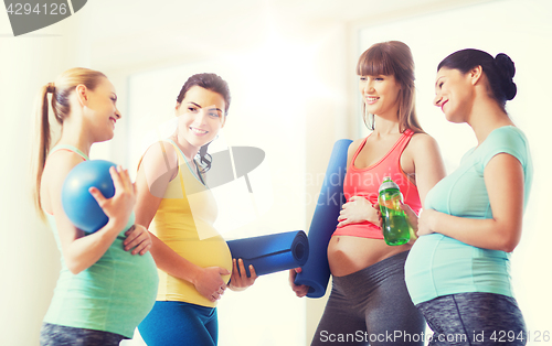 Image of group of happy pregnant women talking in gym