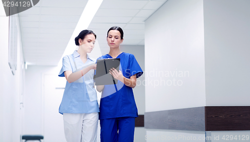 Image of two medics or nurses at hospital with clipboard