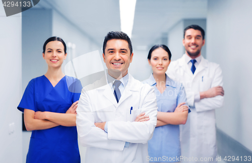 Image of happy group of medics or doctors at hospital