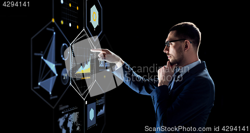 Image of businessman with virtual screen over black