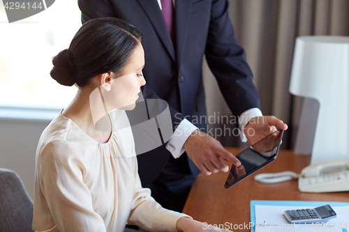 Image of business team with tablet pc working at hotel room