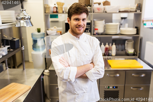 Image of happy male chef cook at restaurant kitchen