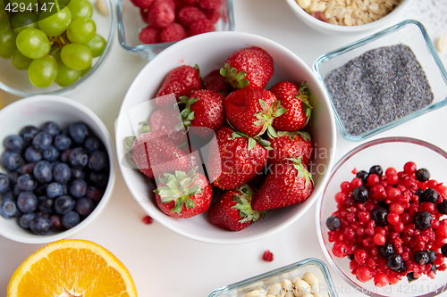 Image of fruits and berries in bowls on table