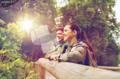 Image of smiling couple with backpacks in nature