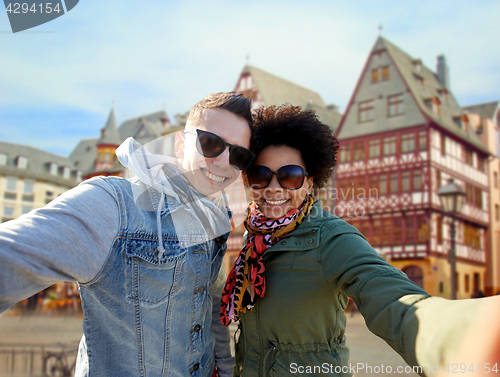 Image of happy couple taking selfie in frankfurt city
