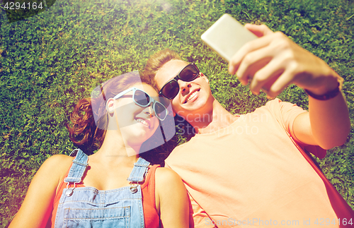 Image of happy couple taking selfie on smartphone at summer