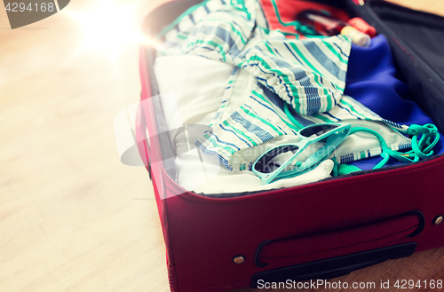 Image of close up of travel bag with beach clothes