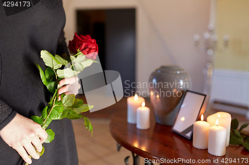 Image of woman with cremation urn at funeral in church