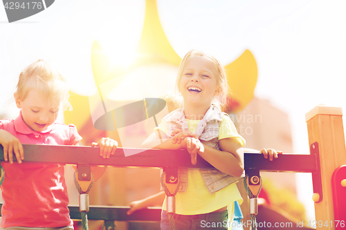 Image of happy little girls on children playground