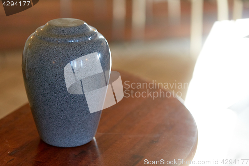 Image of cremation urn on table in church