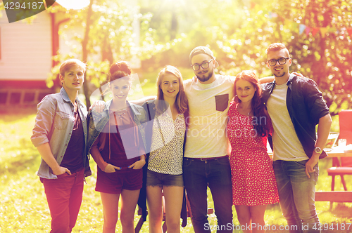 Image of happy teenage friends hugging at summer garden