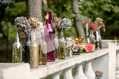 Image of Burning candle in the vintage black bottle