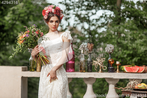 Image of Wedding decoration in the style of boho, floral arrangement, decorated table in the garden.