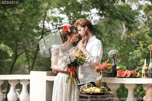 Image of Wedding decoration in the style of boho, floral arrangement, decorated table in the garden.