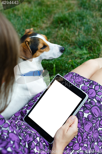 Image of Woman on grass with tablet