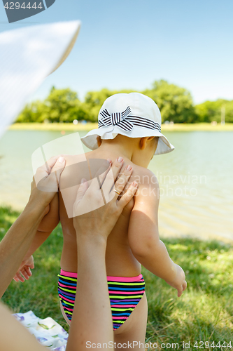 Image of Parent applying cream on child