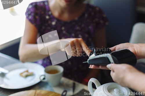 Image of Woman paying his bill in restaurant