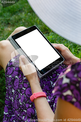 Image of Woman on grass with tablet