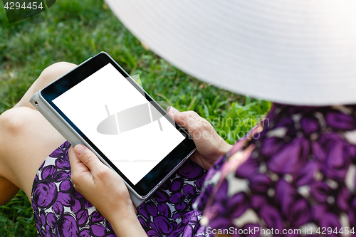 Image of Woman on grass with tablet