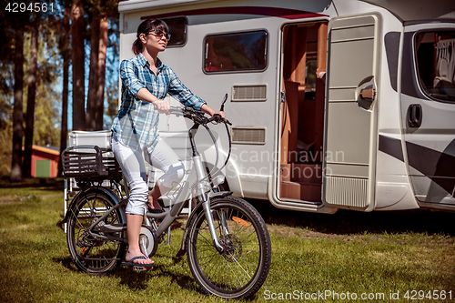 Image of Woman on electric bike resting at the campsite