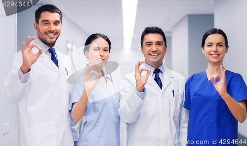 Image of group of medics at hospital showing ok hand sign