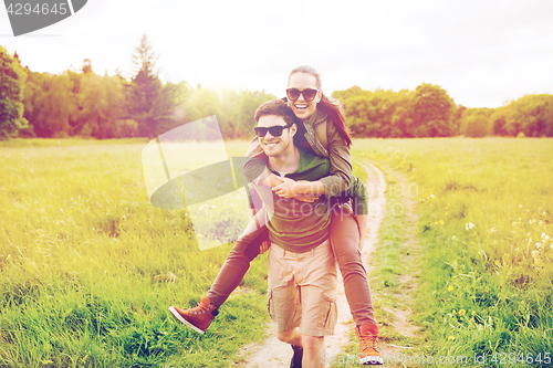 Image of happy couple with backpacks having fun outdoors