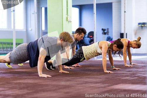 Image of group of people exercising in gym