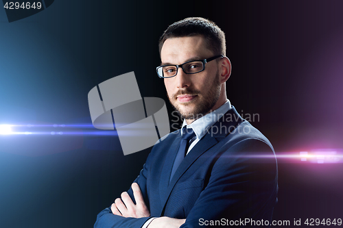 Image of businessman in glasses over black