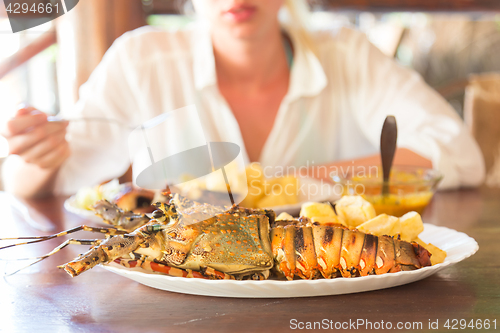 Image of Grilled lobster served with potatoes and coconut sauce.